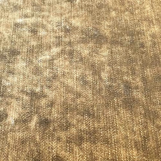 Close-up of a warm latte-beige plain fabric with softly mottled texture