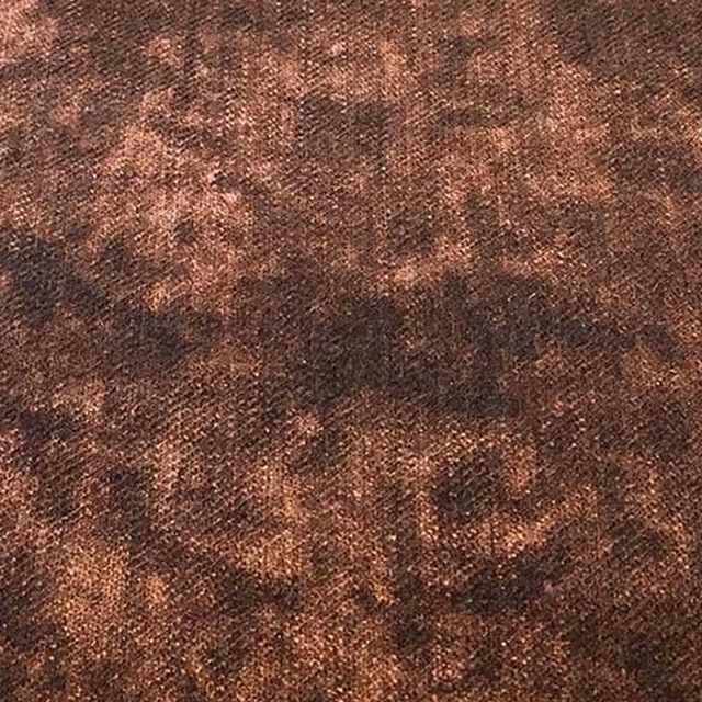 Close-up of a mottled mauve-plum plain weave fabric with warm brown shading