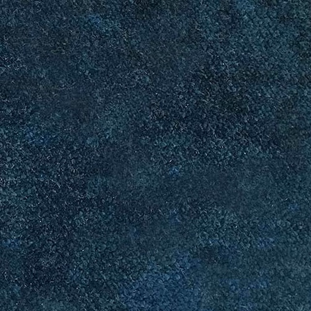 Close-up of deep petrol blue plain fabric with a soft, mottled texture