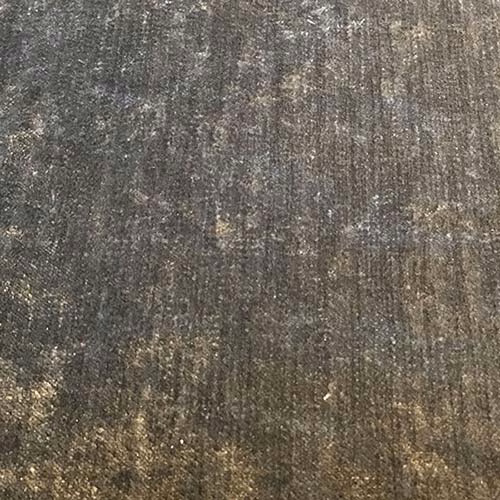 Close-up of a warm pewter-grey plain weave fabric with mottled olive-brown highlights