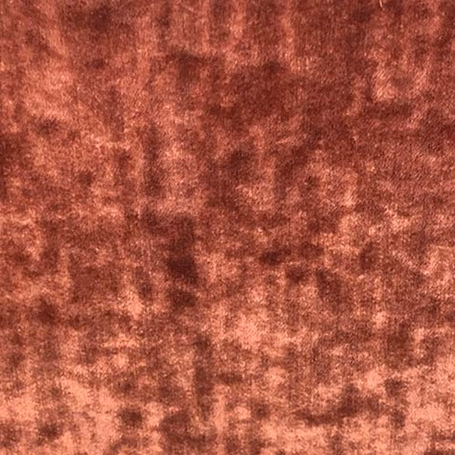 Close-up of a mottled russet terracotta plain fabric with a velvety finish