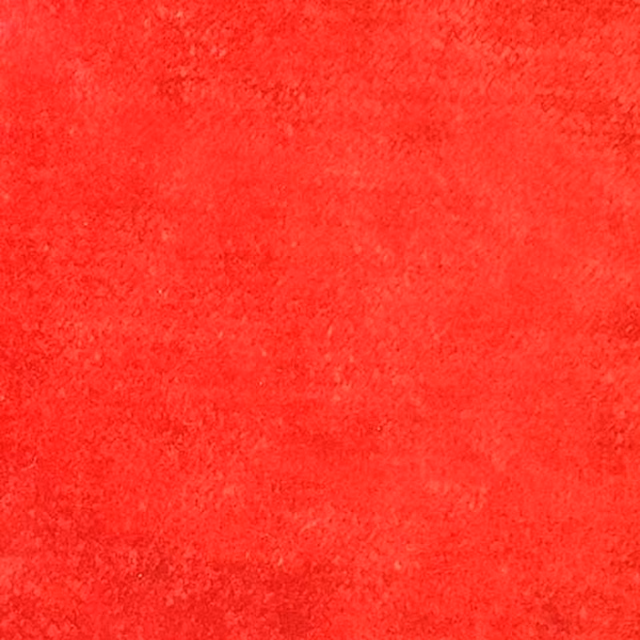 Close-up of bright cherry red plain fabric with a soft, velvety texture
