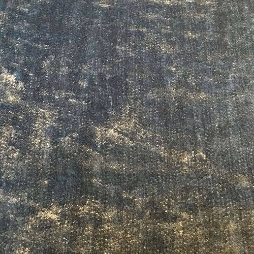 Close-up of smoky slate grey plain fabric with pale mottled flecks and textured weave