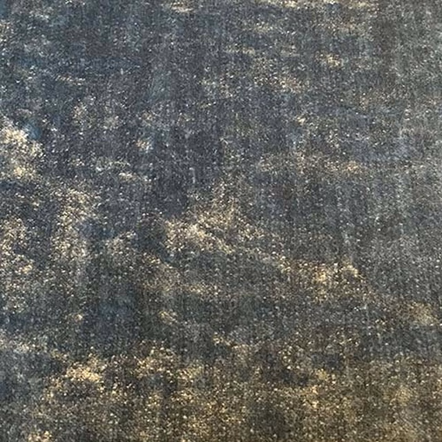 Close-up of smoky slate grey plain fabric with pale mottled flecks and textured weave