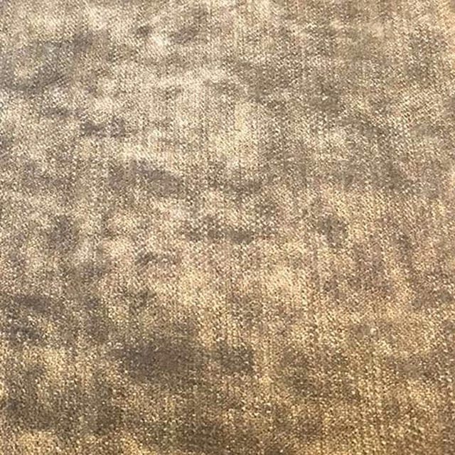 Close-up of warm taupe plain fabric with a mottled, softly weathered texture