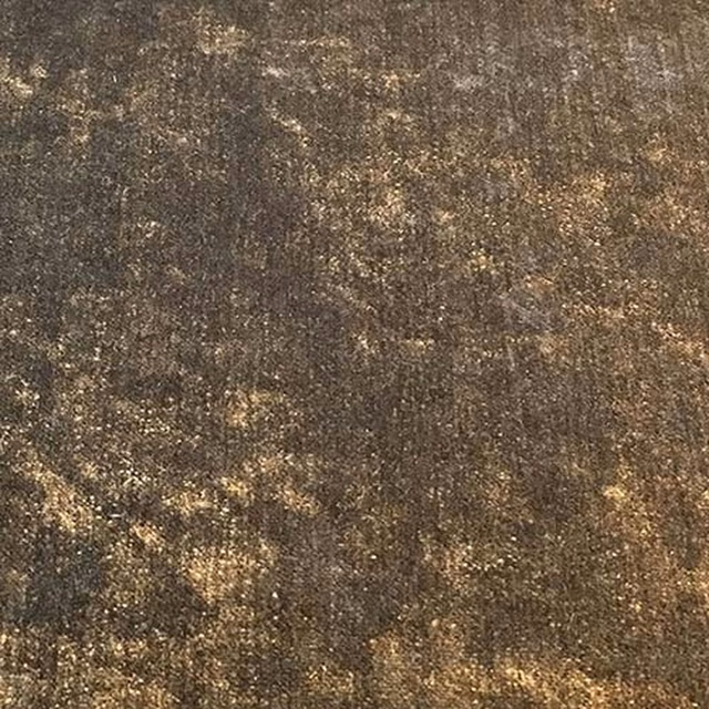 Close-up of a deep truffle-brown plain fabric with golden mottled flecks and subtle texture.
