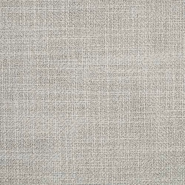 Close-up of a pale mist grey woven plain fabric with fine speckled texture