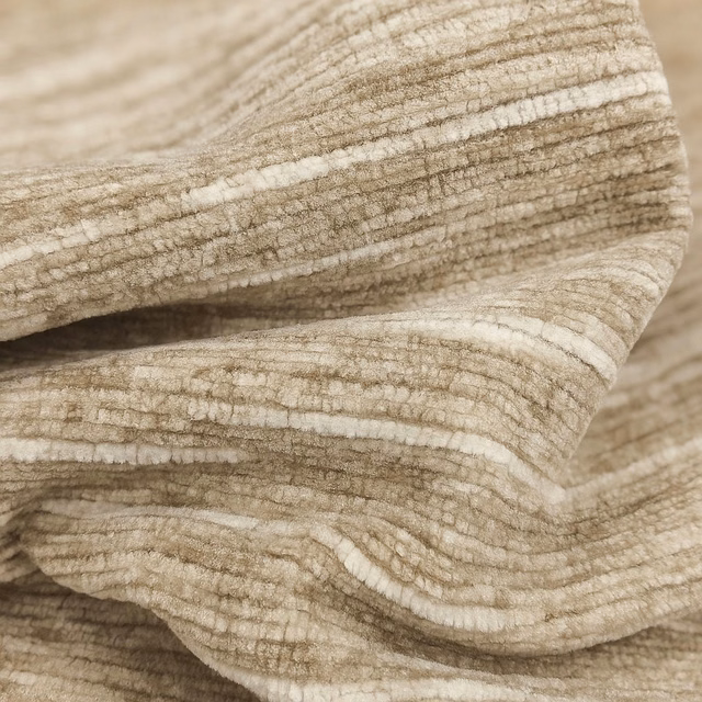 Close-up of warm barley beige ribbed plain fabric with soft cream tonal striations