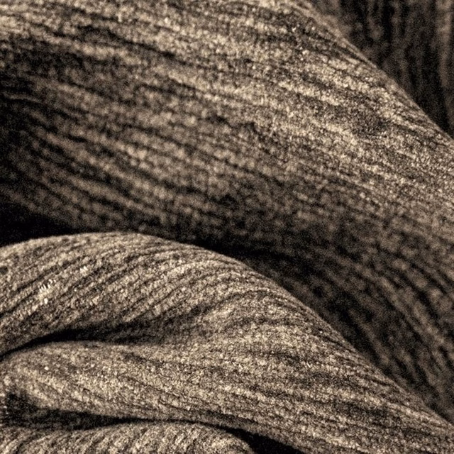 Close-up of a warm cappuccino brown plain woven fabric with subtle heathered texture