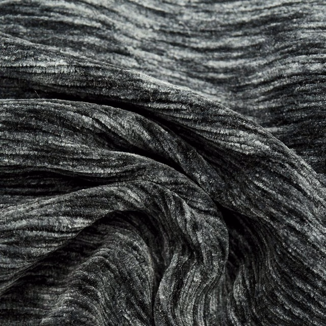 Close-up of charcoal grey crushed plain fabric with silver highlights