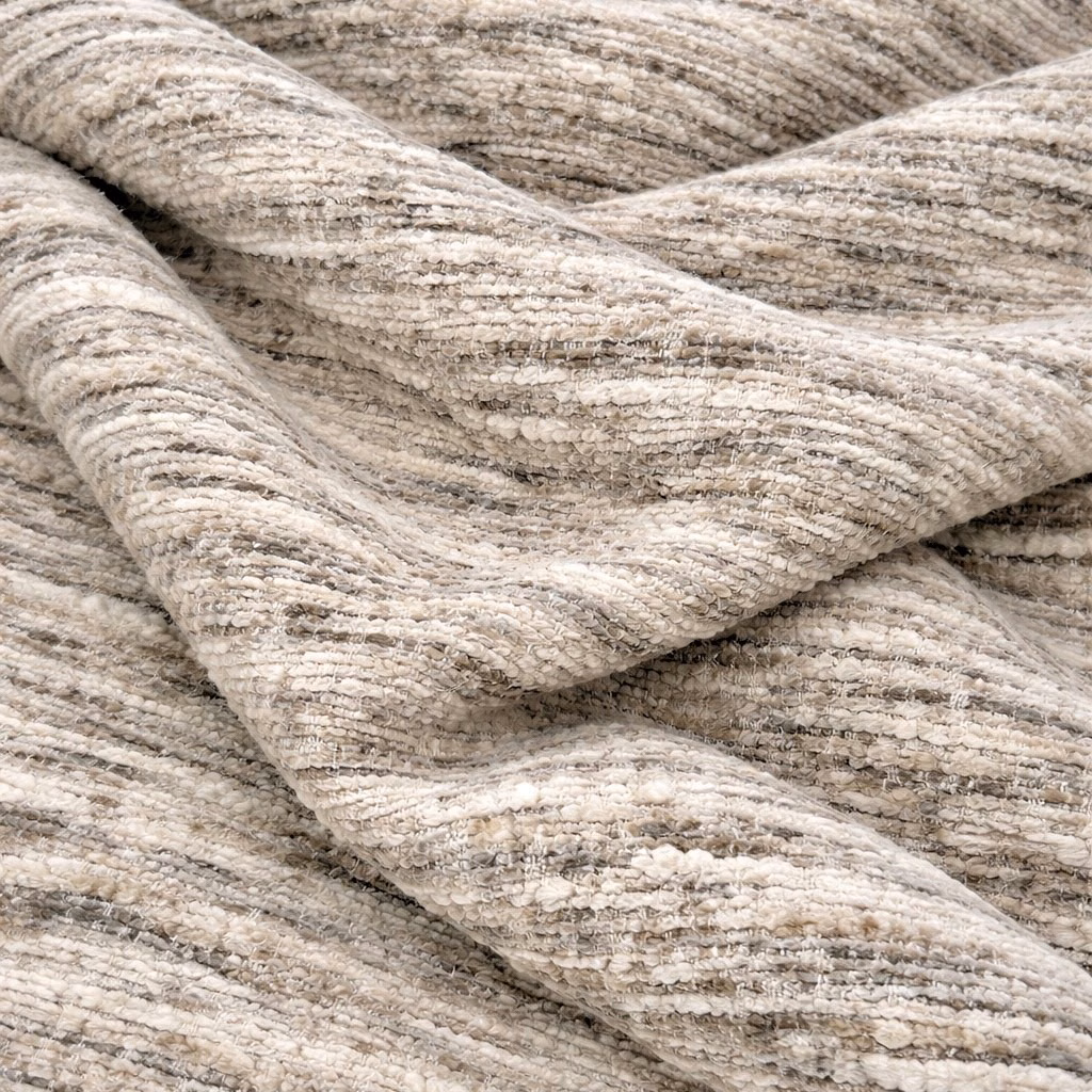 Close-up of Osaka Marble fabric in warm cream and beige marled texture