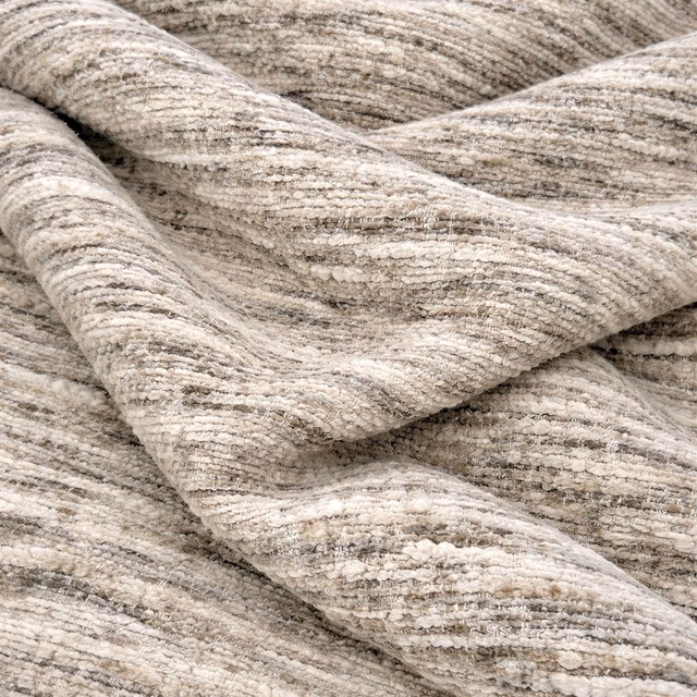 Close-up of Osaka Marble fabric in warm cream and beige marled texture
