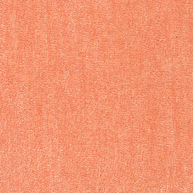 Close-up of a soft salmon-pink plain woven fabric with fine textured surface