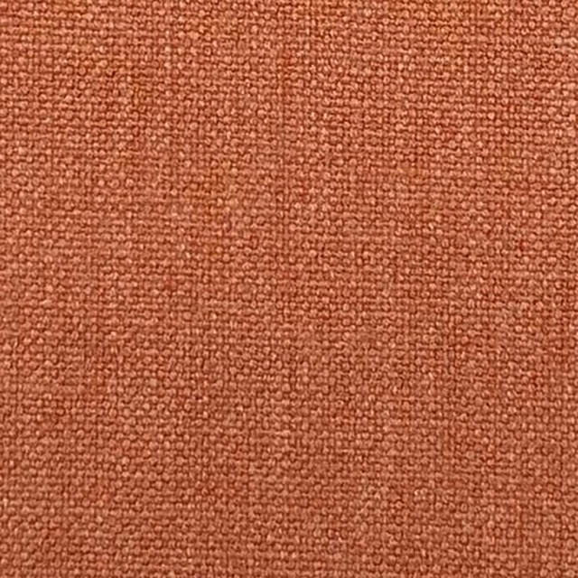 Close-up of warm terracotta plain weave with a nubby textured surface