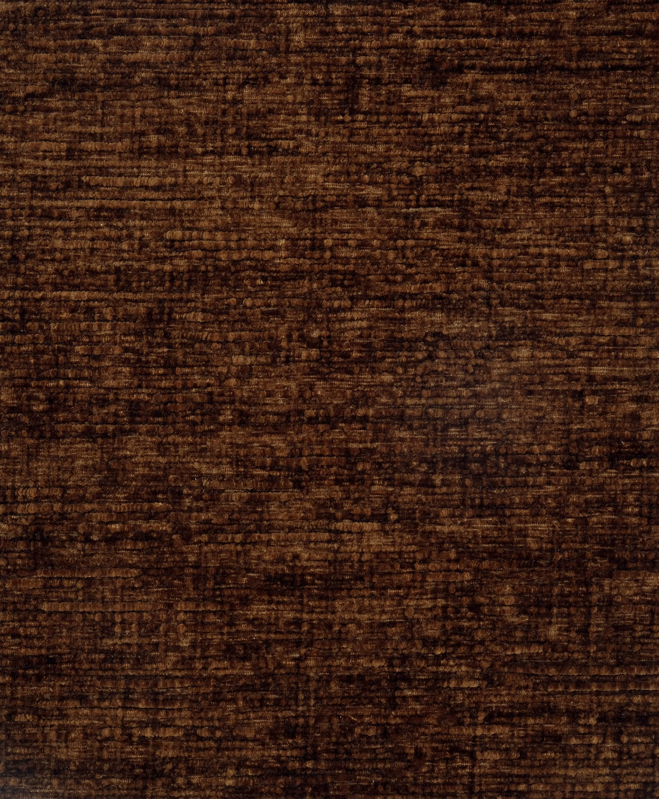 Close-up swatch of deep rust-brown plain fabric with soft velvety texture