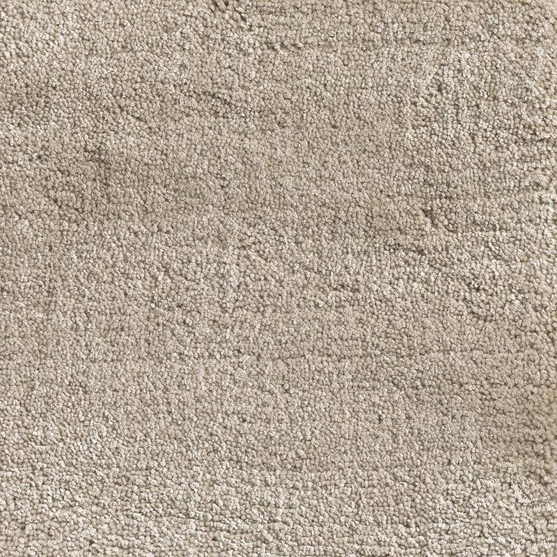 Warm oatmeal carpet textile with dense nubby loops and softly mottled beige shading
