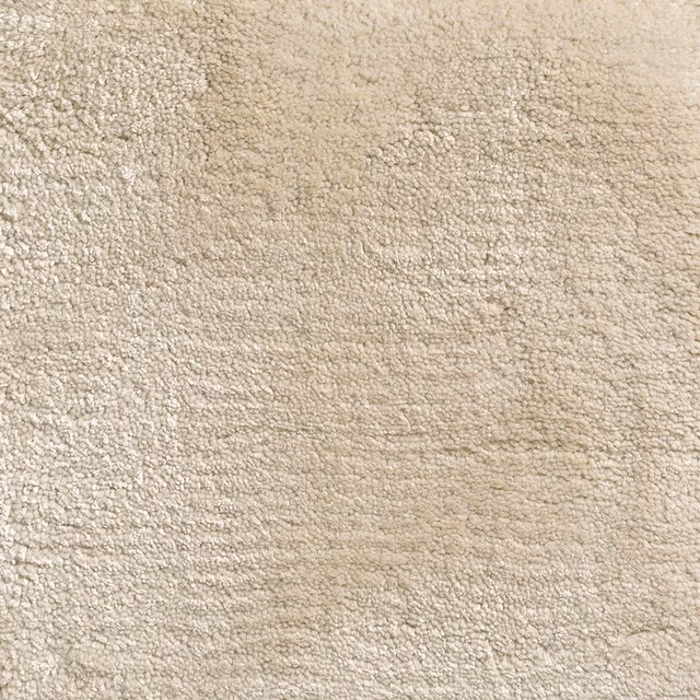 Warm oyster-beige carpet textile with dense, softly flecked nubby texture