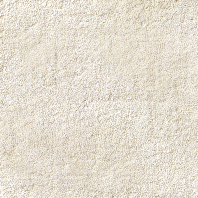 Soft ivory cream carpet showing dense irregular loops and subtle tonal flecks
