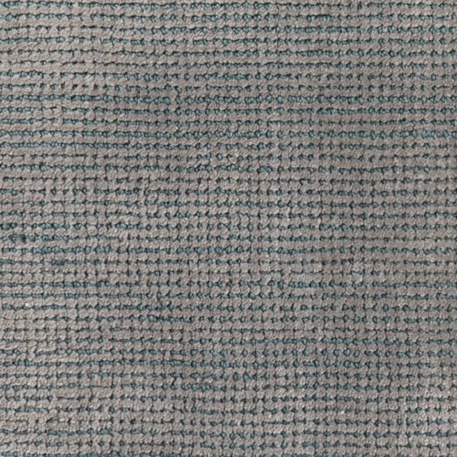 Muted malachite teal and grey woven carpet with dense irregular looped texture