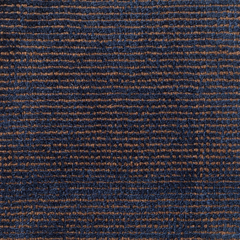 Deep navy and russet-brown carpet weave with irregular horizontal ridges
