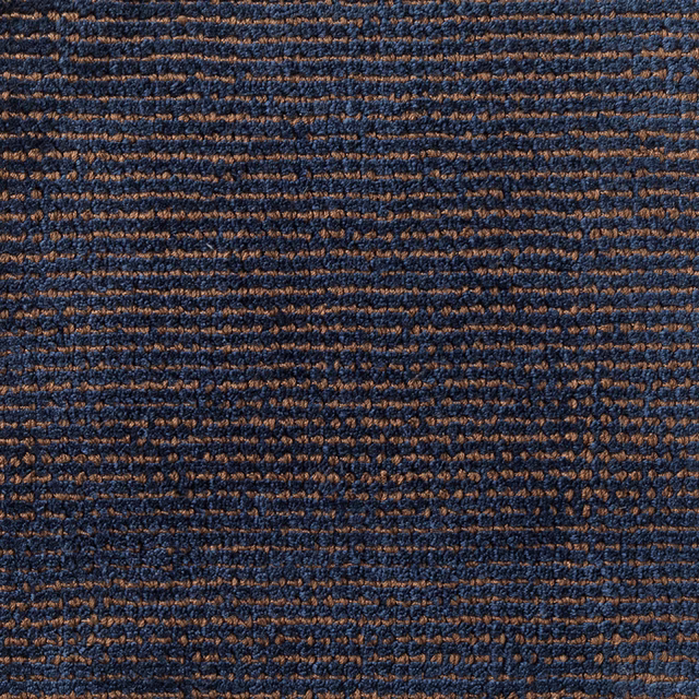 Deep navy and russet-brown carpet weave with irregular horizontal ridges