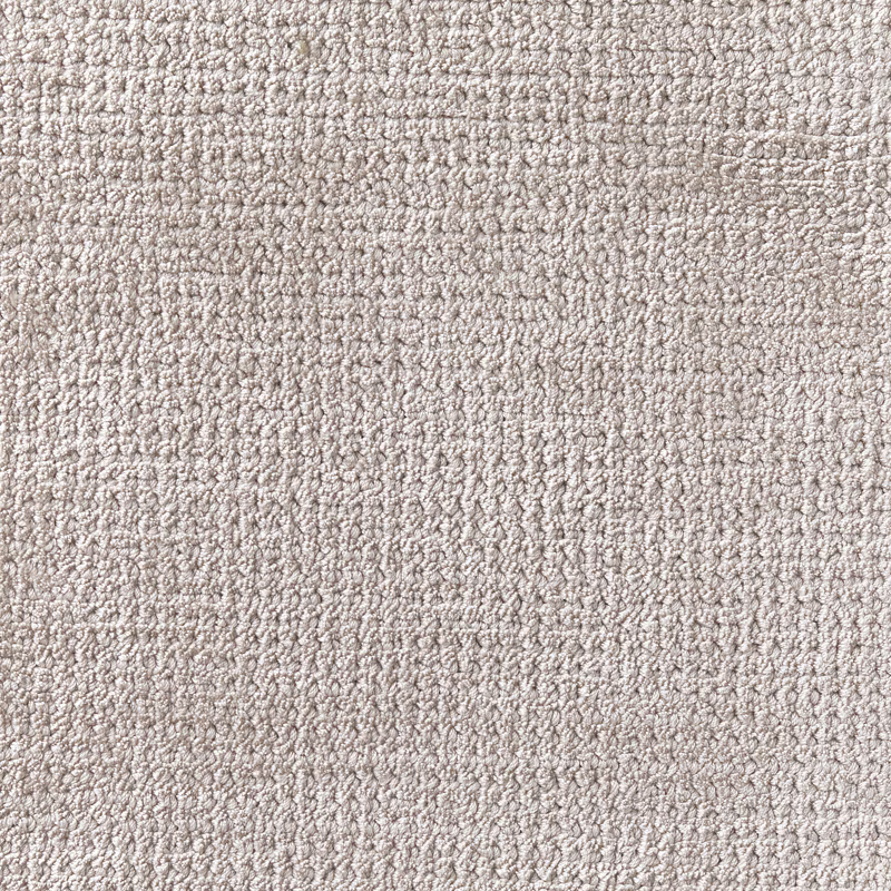 Close-up of pale cloudy grey carpet with dense nubby, softly mottled texture