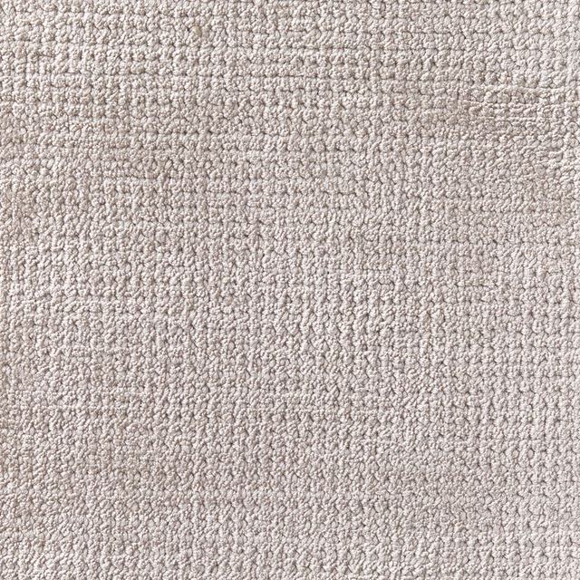 Close-up of pale cloudy grey carpet with dense nubby, softly mottled texture