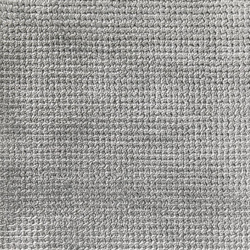 Close-up of cool teal-blue carpet texture with dense pale and dark loops