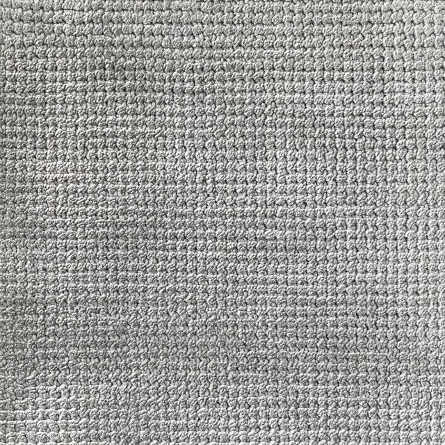 Close-up of cool teal-blue carpet texture with dense pale and dark loops