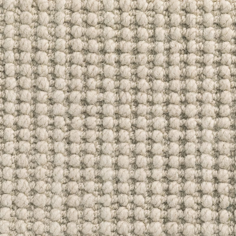 Warm oatmeal Millet carpet textile with chunky pale loops and mottled grey flecks