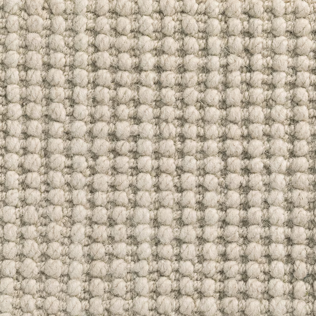 Warm oatmeal Millet carpet textile with chunky pale loops and mottled grey flecks
