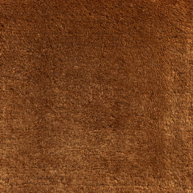Close-up of dense maple-brown carpet pile with russet and chocolate tonal variation