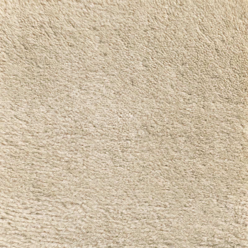 Close-up of warm oat-beige Pampas carpet with irregular softly raised textured pile