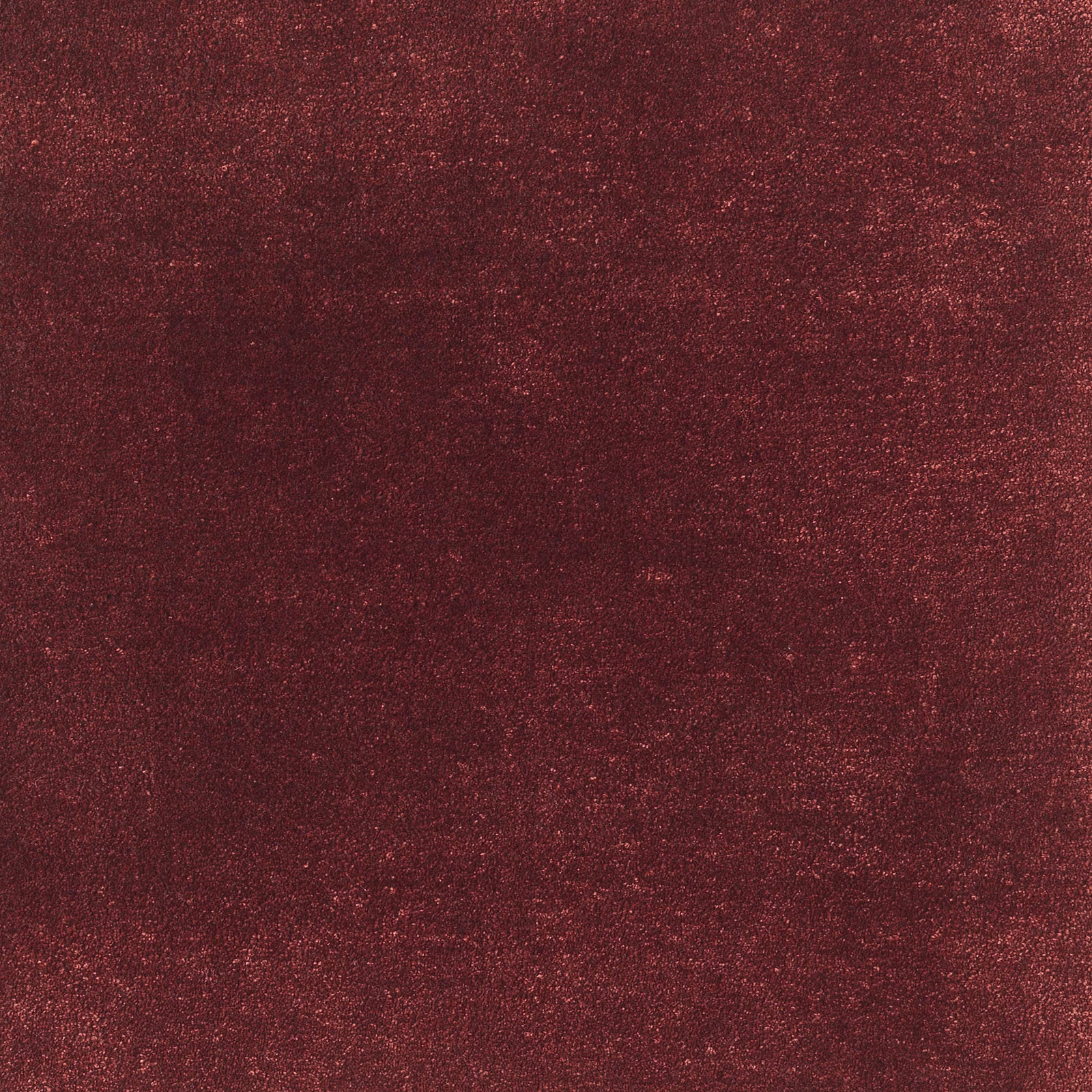 Deep carmine red carpet textile with mottled texture and subtle glowing flecks
