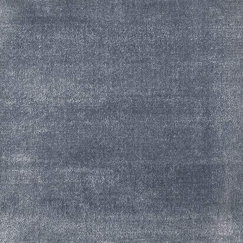 Close-up of muted cornflower blue-grey carpet with fine, grainy tonal texture