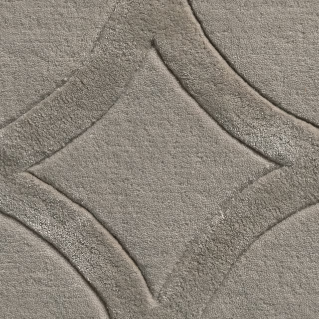 Close-up of cool pebble-grey carpet with plush texture and curved geometric bands