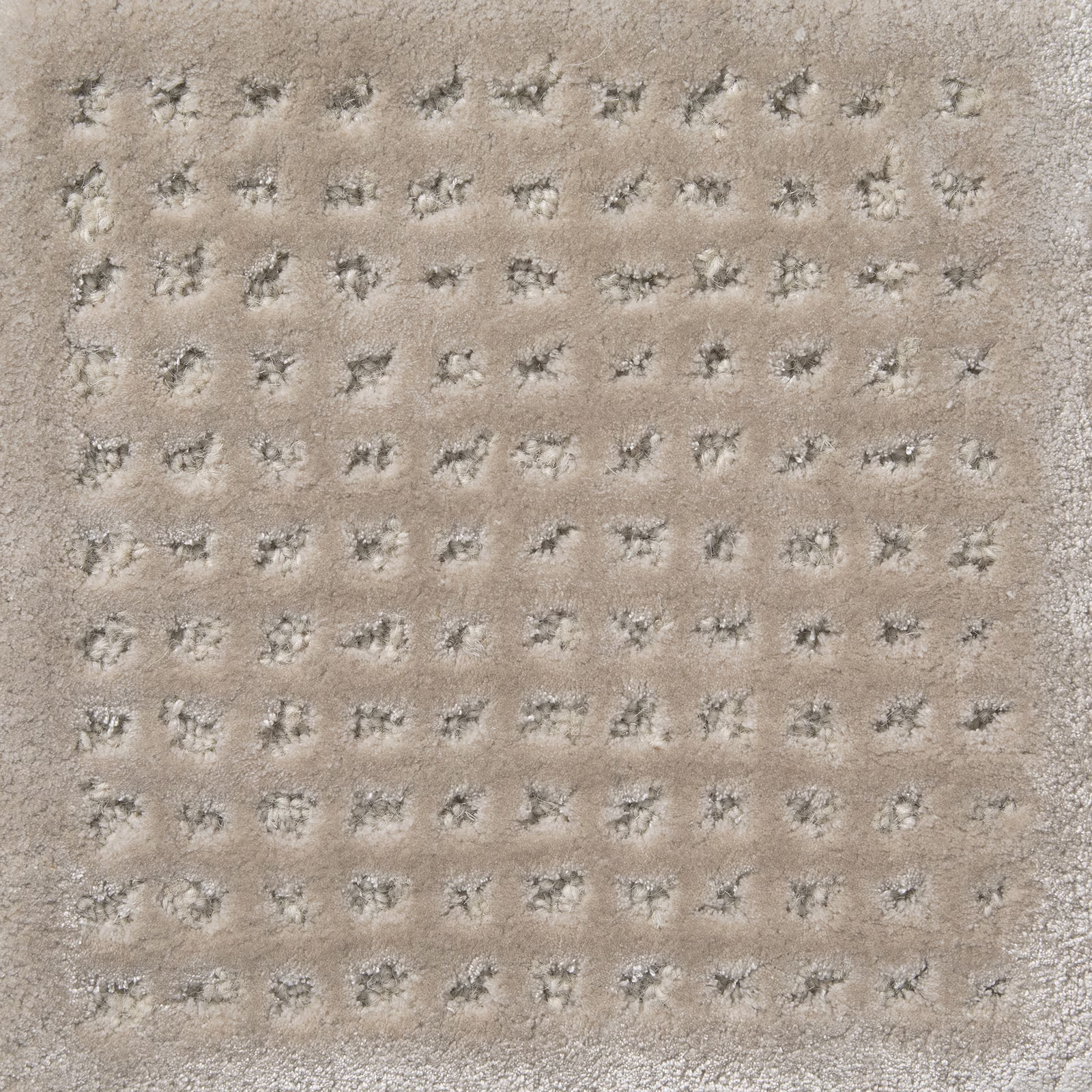 Warm platinum-beige pile with small charcoal-grey tufted lattice marks
