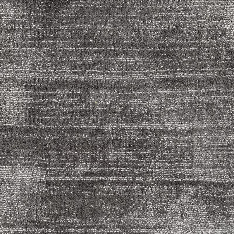 Mottled charcoal-grey carpet textile with irregular horizontal striations and nubby texture