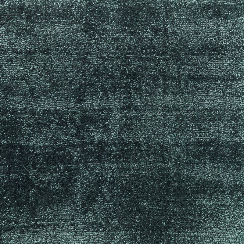 Dense mottled blue-green teal textile with a rough, softly irregular woven surface