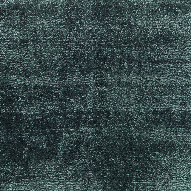 Dense mottled blue-green teal textile with a rough, softly irregular woven surface