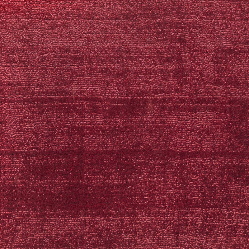 Deep garnet-red carpet with dense horizontal texture and subtly variegated burgundy shading