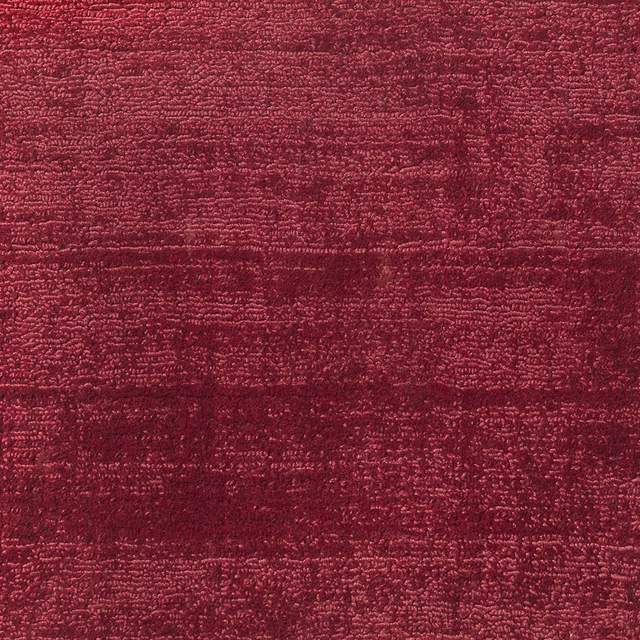 Deep garnet-red carpet with dense horizontal texture and subtly variegated burgundy shading