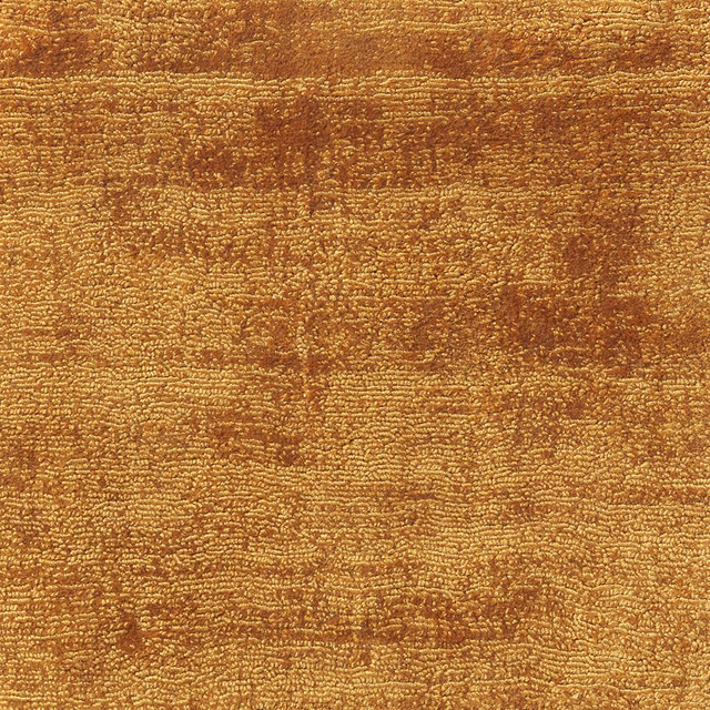Warm ochre-gold textured carpet with irregular brown horizontal tonal bands