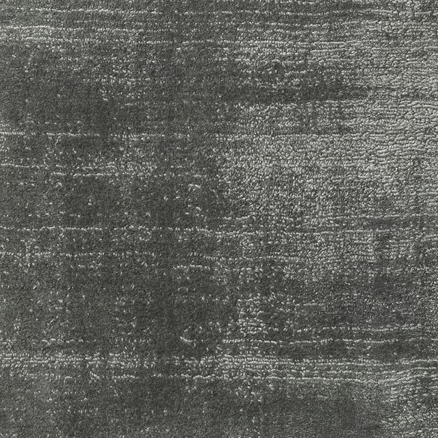 Charcoal-grey carpet texture with broken horizontal bands and silvery flecked highlights