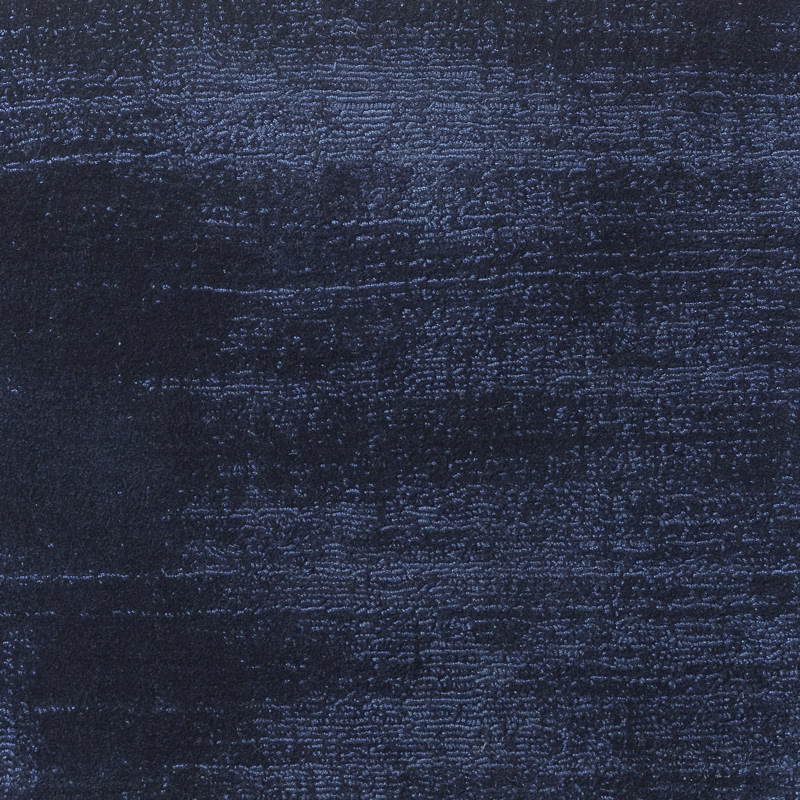 Deep navy textile with rippled horizontal texture and subtle blue highlights