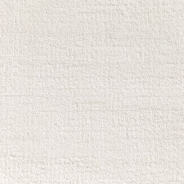 Close view of warm white nubby carpet texture with subtle woven tonal variation