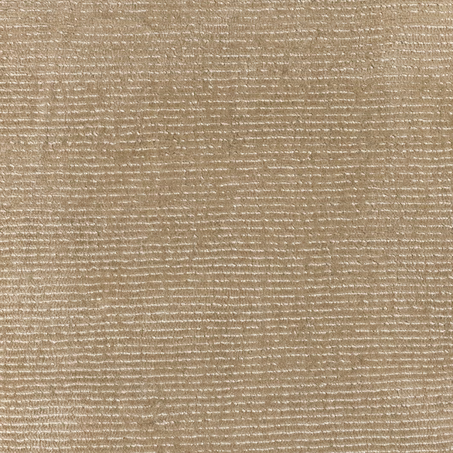 Warm wheat-beige woven surface with irregular horizontal ivory flecks and fine slubs
