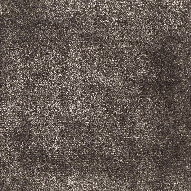 Close view of dense charcoal-grey carpet with subtle mottled texture and low relief