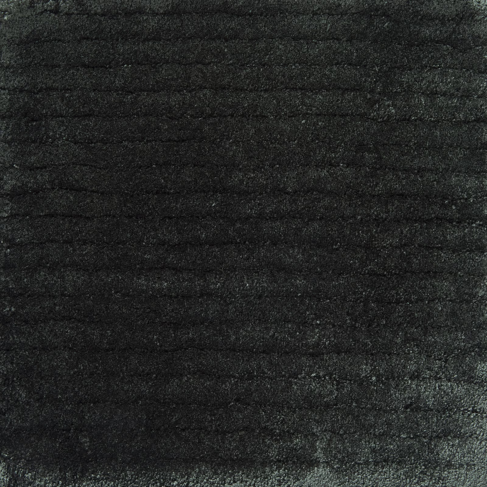 Close-up of charcoal-black Holly carpet with dense horizontal brushed texture