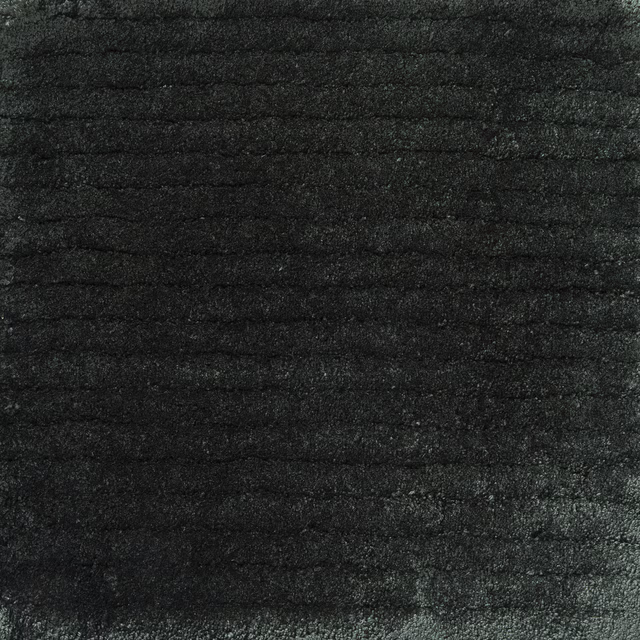 Close-up of charcoal-black Holly carpet with dense horizontal brushed texture